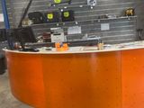 a large orange counter in a garage with tools on the counter