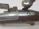a close up of a gun with a knife in it