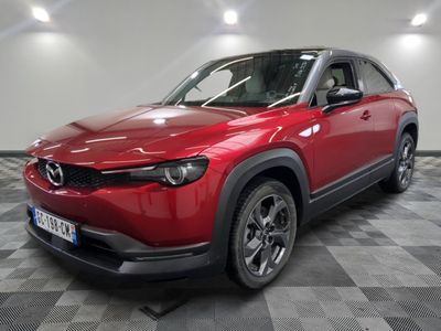 the red mazda cx - hr suv is parked on a checkered floor