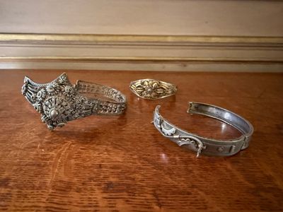 two rings and a ring on a wooden table