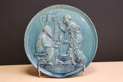 a blue plate with a picture of a man and a woman sitting at a table