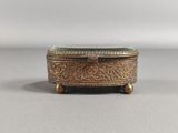 an antique brass box with a green glass top