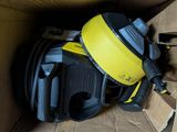 a yellow and black helmet in a cardboard box