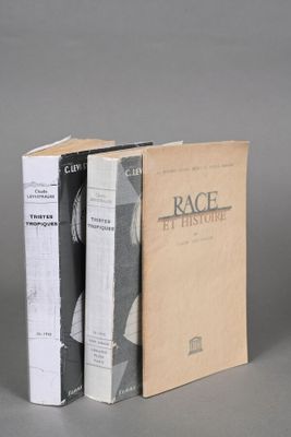 three books are stacked on top of each other on a table