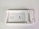 a small white object on a table with a white background