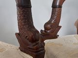 two chairs that are made of wood with carved horns on them