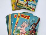 a bunch of mickey mouse comics are stacked on top of each other