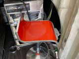 a red chair that is sitting in the corner of a room