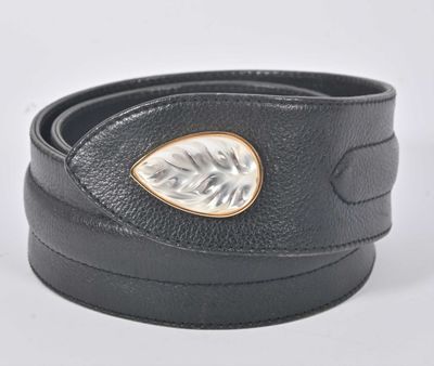 un gros plan sur une ceinture en cuir noir dotée d'une boucle argentée