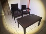 two chairs and a table in a small room