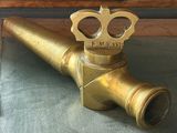 a brass pipe that has a crown on top of it