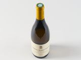 a bottle of wine sitting on top of a white table