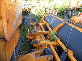 a yellow machine that is sitting on the side of the road