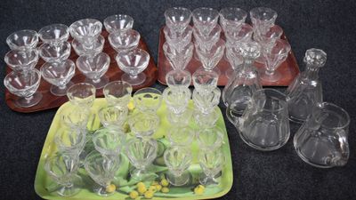 a lot of empty wine glasses and a tray of empty wine glasses
