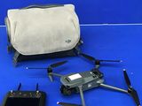 a bag, remote control, and a bag on a blue surface
