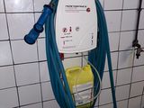a blue hose attached to a wall in a bathroom