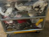 a cart full of shoes that are sitting on the floor