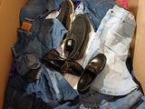 a cardboard box filled with clothes and a pair of shoes