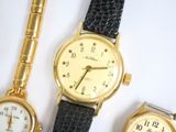 three different types of watches are displayed on a white surface