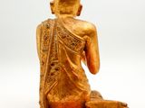 statue of a person sitting in a lotus position on a white background