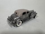 a toy car that is sitting on a white surface