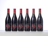 six bottles of red wine lined up in a row