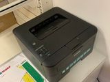 a printer sitting on top of a desk next to a printer