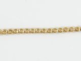 a close up of a gold chain on a white background