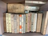 a box full of old books sitting on a table