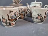 four cups and a saucer sitting on a table