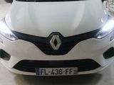 the front end of a white car in a garage
