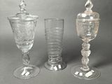 three glass goblets sitting next to each other on a table