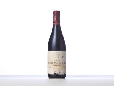 a bottle of red wine sitting on top of a table