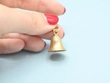 someone is holding a bell in their hand on a blue surface
