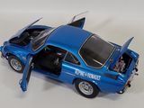 a blue toy car with its doors open on a white surface