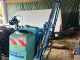 a tractor that is parked next to a blue tank