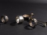 two silver spoons and a spoon rest on a black surface