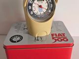 a yellow clock sitting on top of a red box