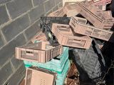 a pile of boxes and crates sitting outside of a building