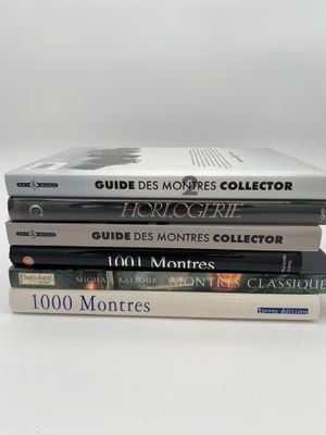 trois livres sont empilés sur une table