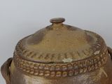 a brown pot with a lid sitting on a table