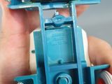 a person holding a blue toy car in their hand