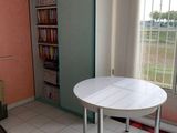 a small white table in the corner of a room