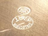 a close up of a metal plate with a logo on it