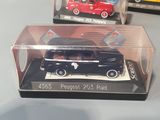 three toy cars in a clear box on a table