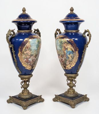 pair of blue and gold vases with images of people on them