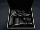 a lot of silverware in a box on a table