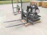 two forklifts that are sitting on a pallet