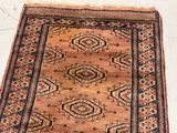 rug on the floor is brown and black with a pattern on it