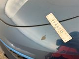 a sticker on the hood of a car with a ruler attached to it